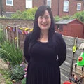Lady looking at the camera stood in her garden