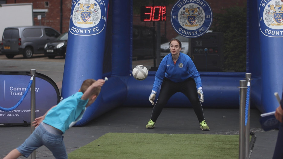 A goalkeeper in front of an inflatable goal.