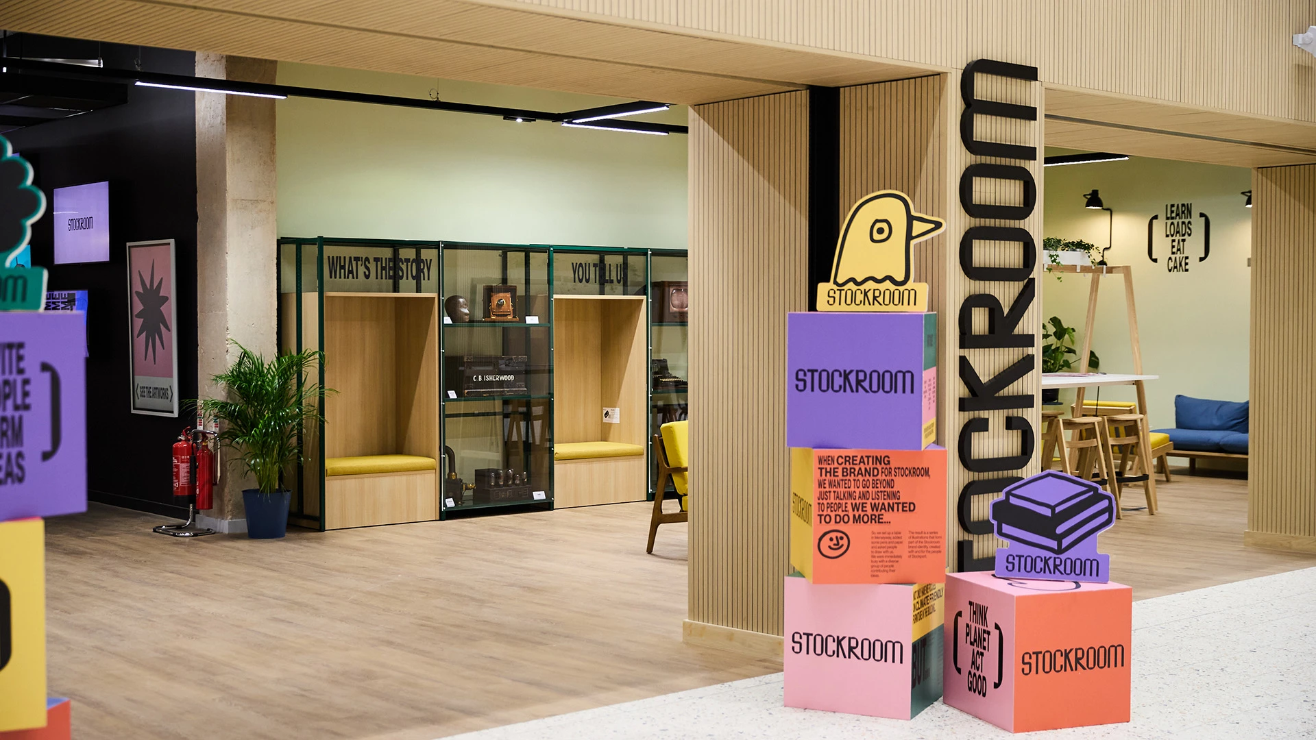 Entrance to Stockroom with colourful boxes stacked, advertising services.