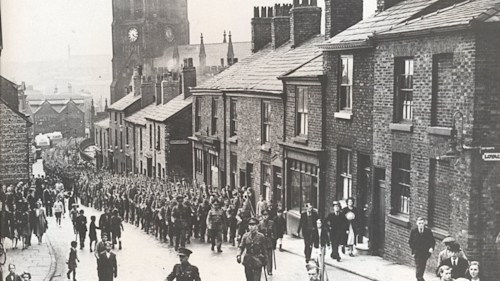 An black and white archive image of WWII troops on Churchgate in Stockport.