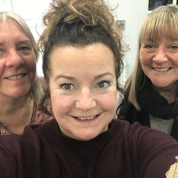 3 women smiling.