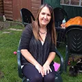 Lady sat on a chair facing the camera