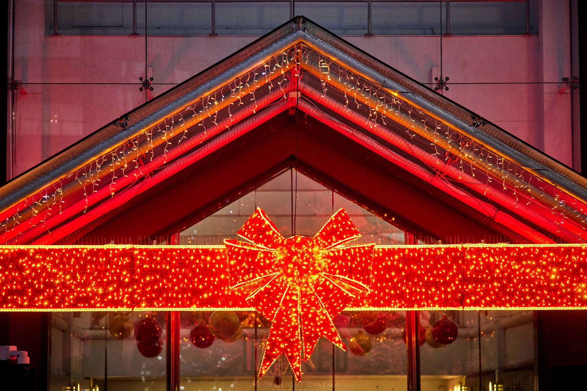 Large red bow at the front of Merseyway shopping centre, full of lights anc sparkle.