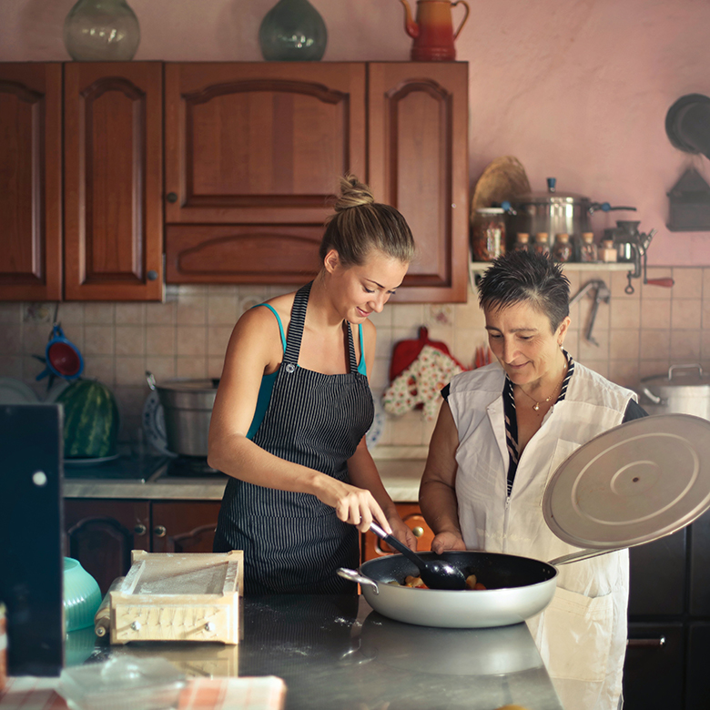 Two women cooking together.