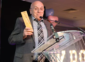 Bernard recieving his award recognising 2 decades of volunteering at Heaton Norris Community Centre