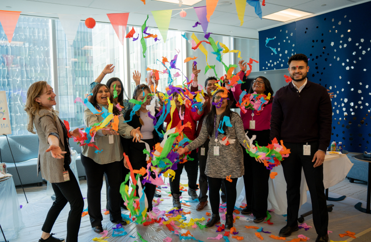 A group of people throwing confetti 