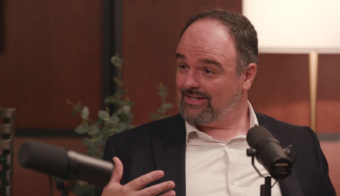 A man sitting in front of a microphone