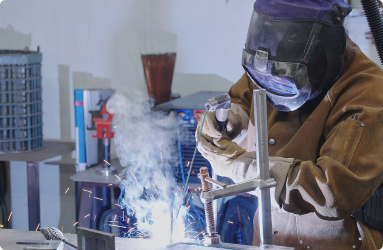 A person welding in a lab