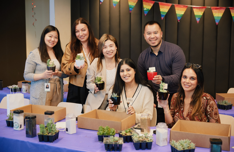 A group of people holding succulents 