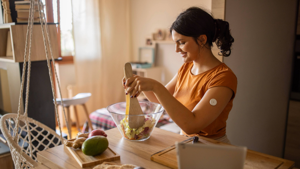 A woman mixing a salad in her kitchen