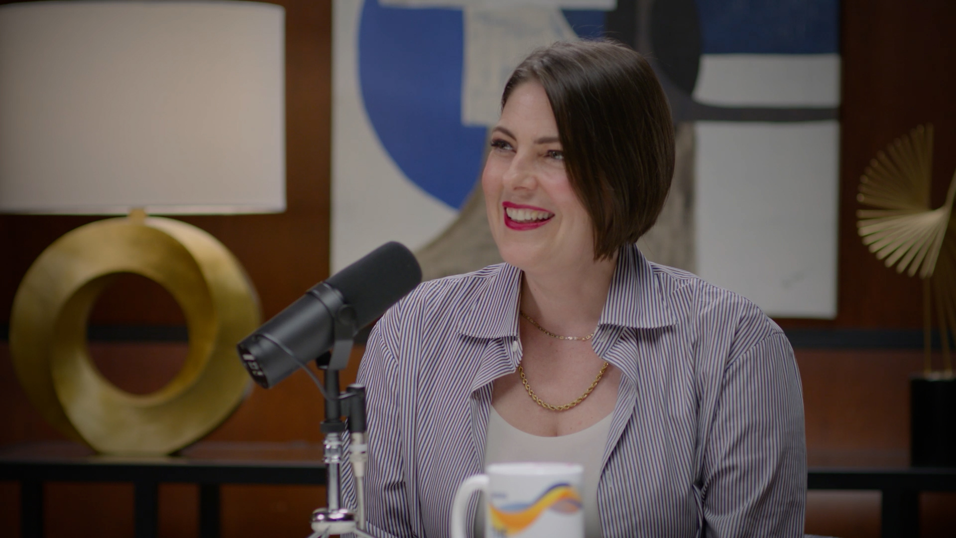 A woman sitting in front of a microphone