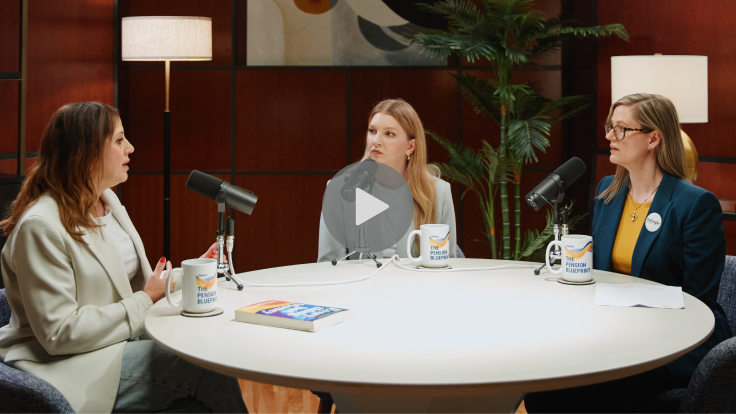 Three women sitting at a table with microphones
