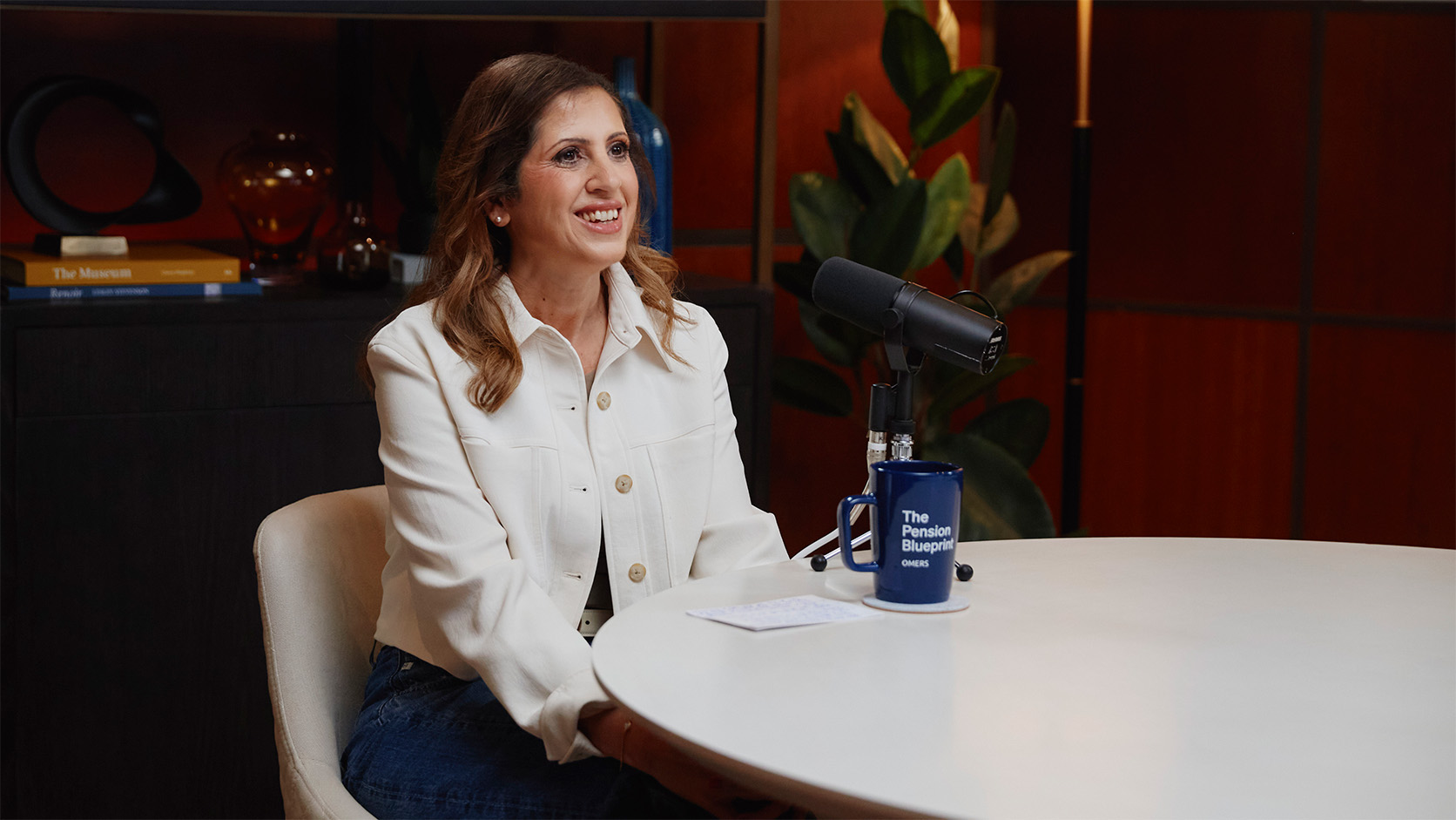 Celine Chiovitti sitting at a table in front of a microphone