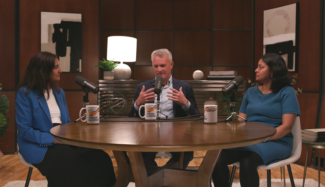 Four people sitting at a table with microphones