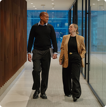 A man and a woman walking down a hallway
