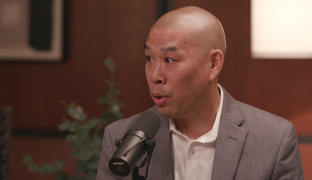 A man sitting at a microphone