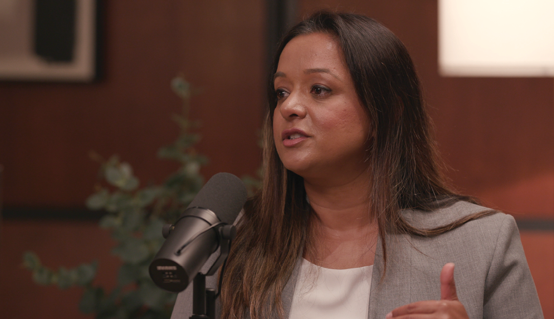 A woman sitting in front of a microphone