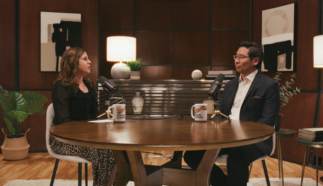 Celine and Dr. Aw sitting at a table with microphones