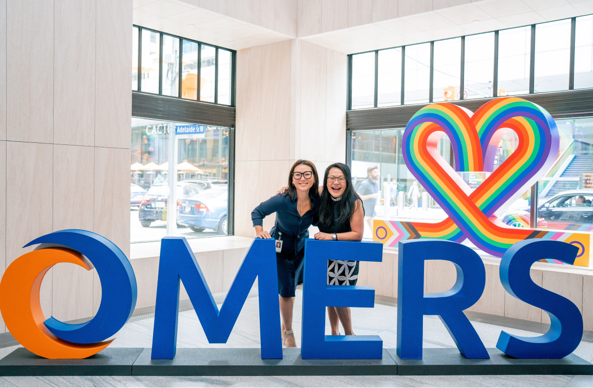 Two women with the OMERS sign