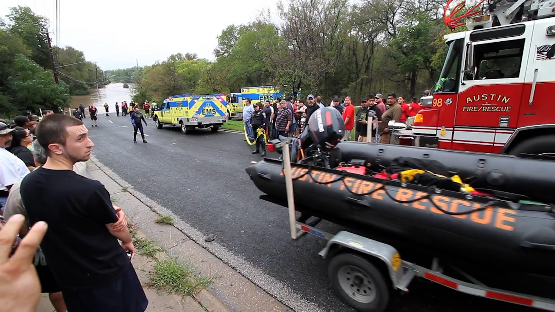 In this photo from 2013, residents look on as the Austin Fire Department launches a rescue boat into the flooded Onion Creek neighborhood to search for survivors. The historic flood devastated the community. Photo courtesy Jonathan Uhl/ ATXN.
