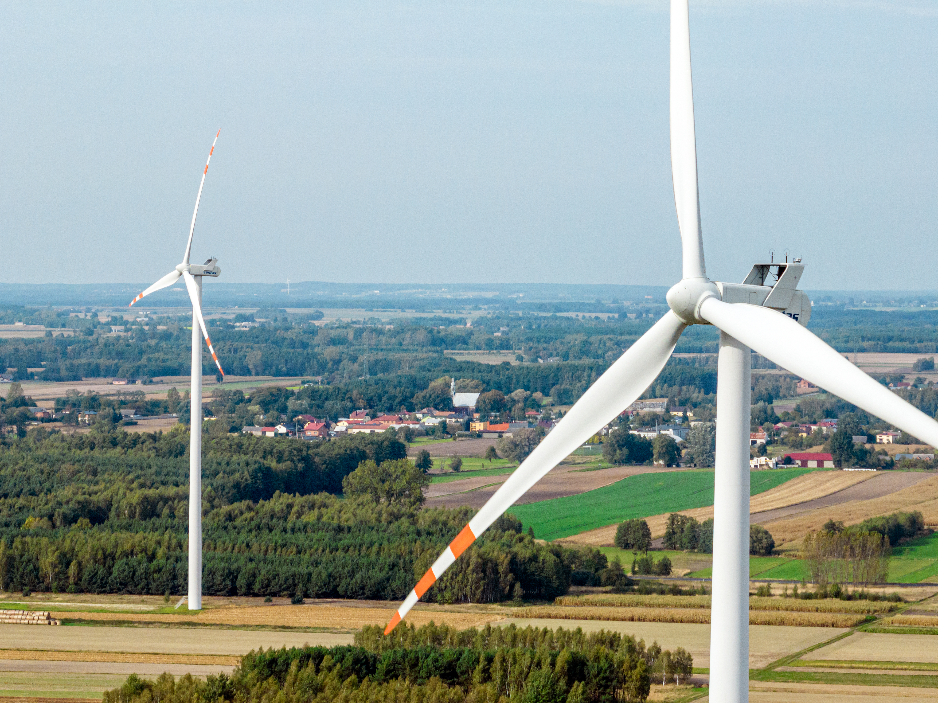 Image of the Rusiec wind farm in Poland. 2 wind turbines in a field.