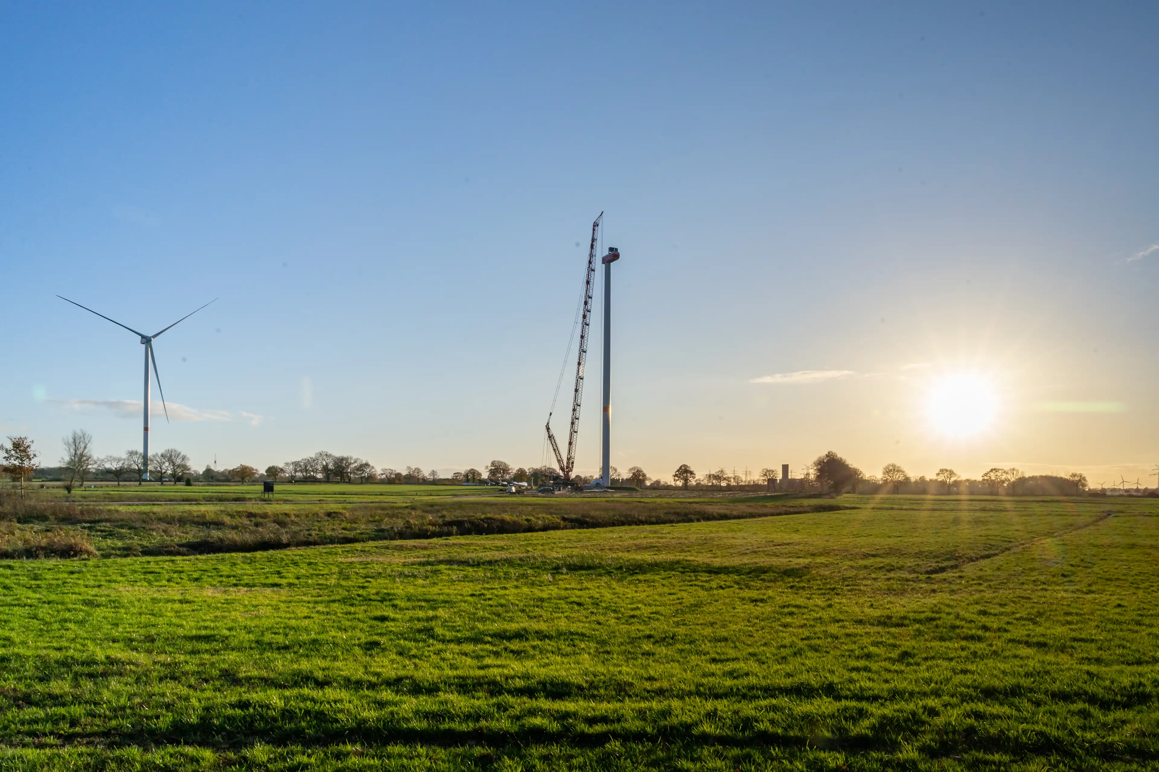 Photo of the construction of a wind turbine in the distance