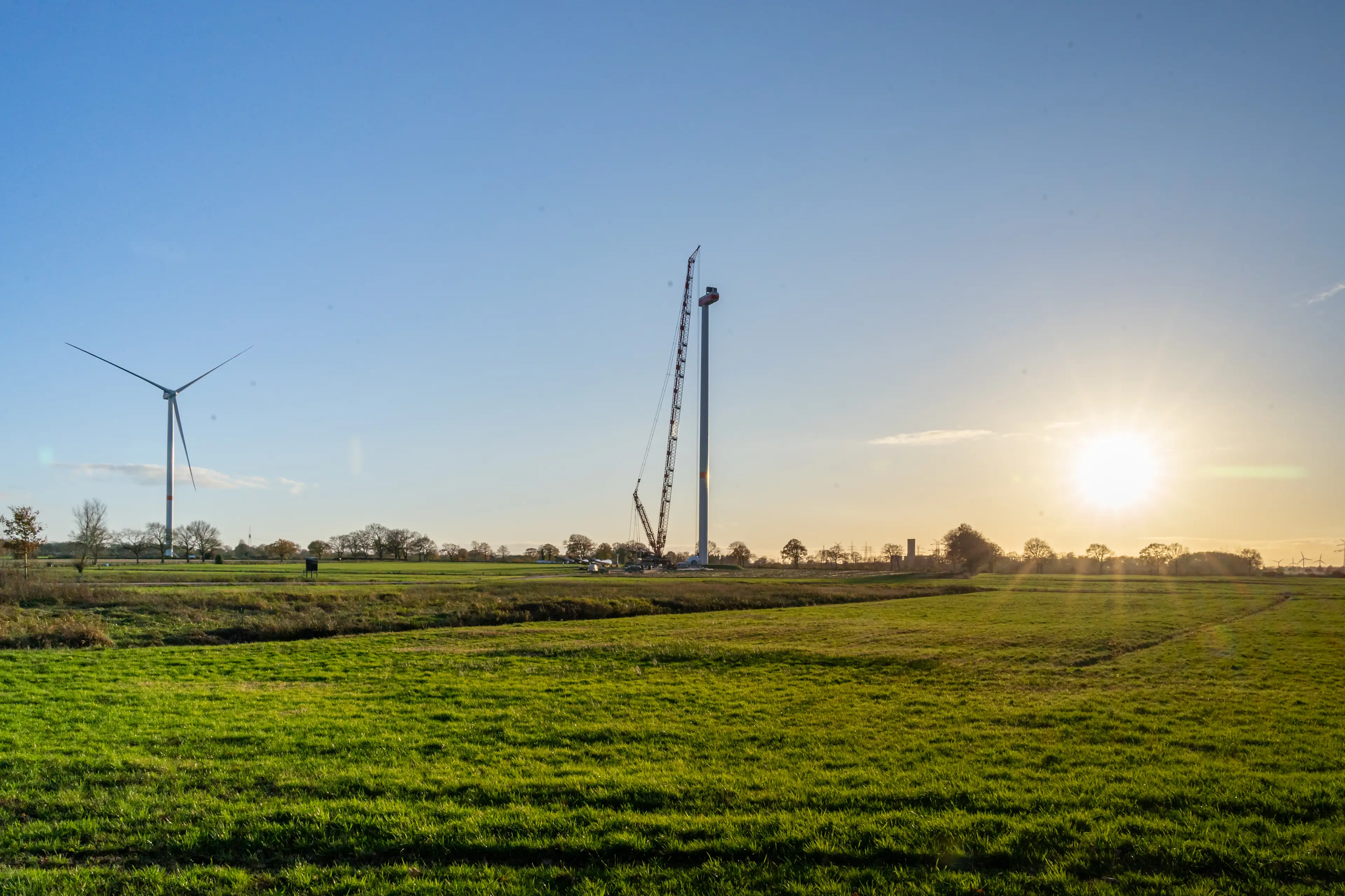 Photo of the construction of a wind turbine in the distance