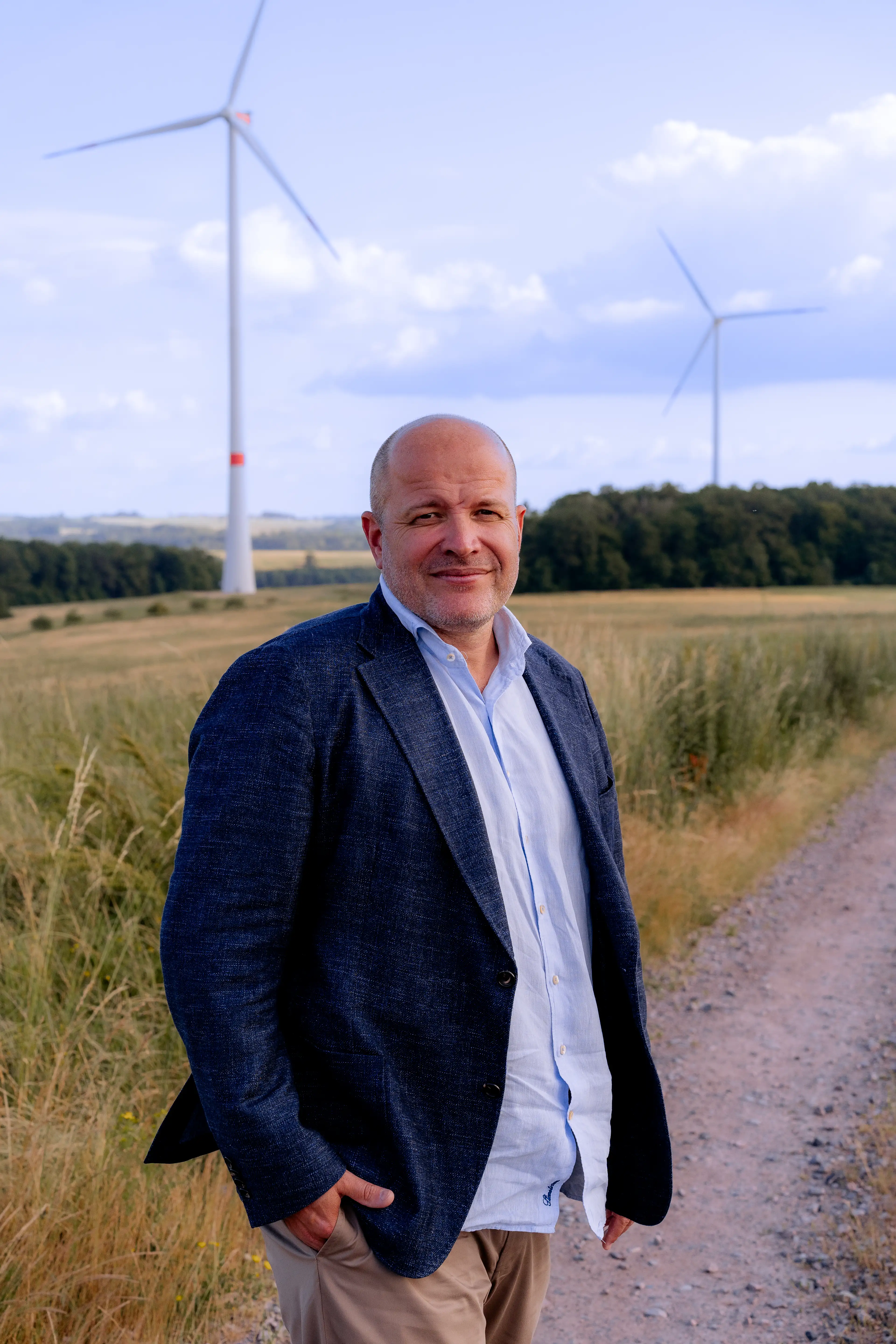 Mr Götz in front of the Staustein wind farm on his land