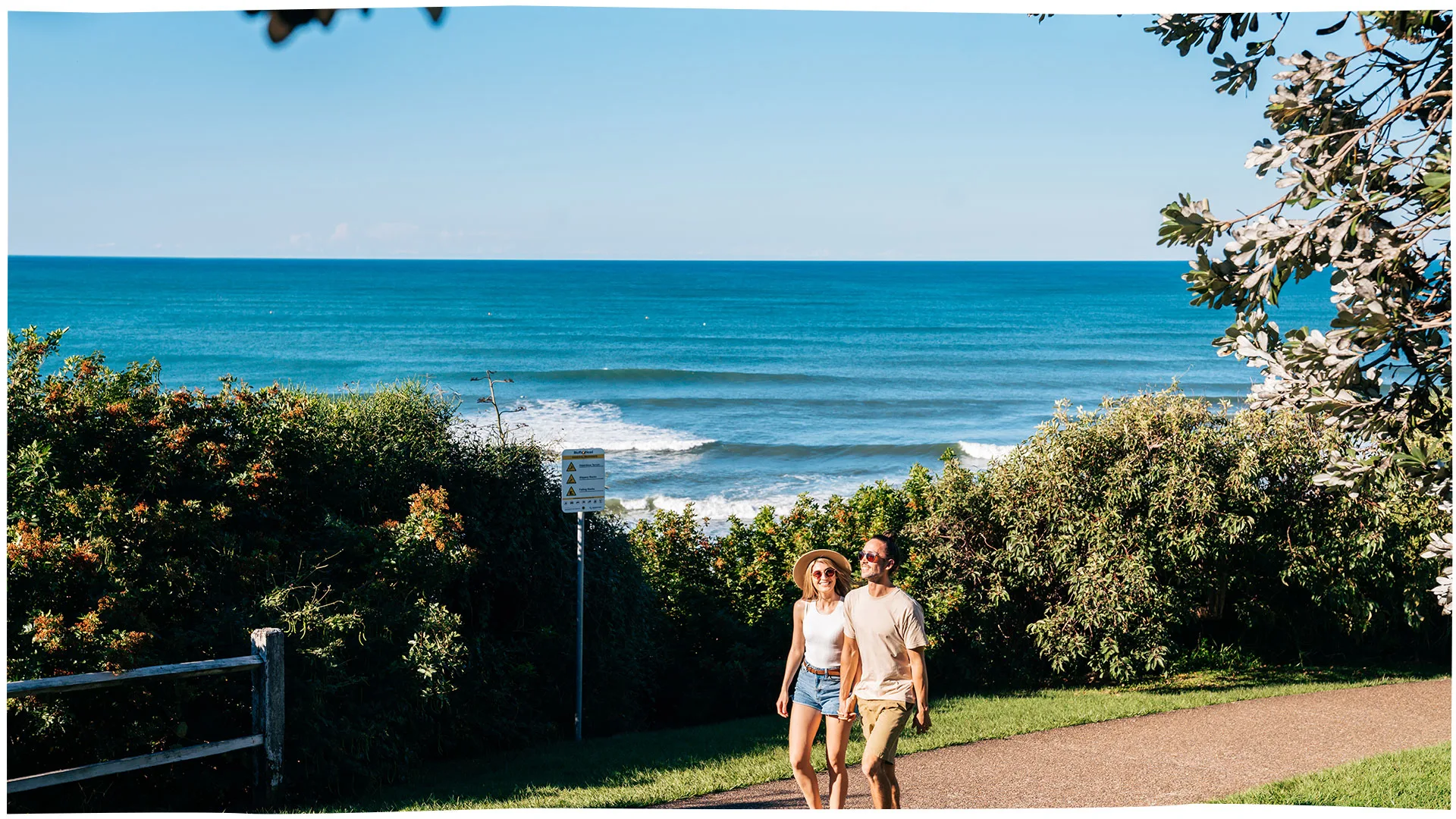 Couple walking along the Coastal Pathway at Moffat Headland, Moffat Beach