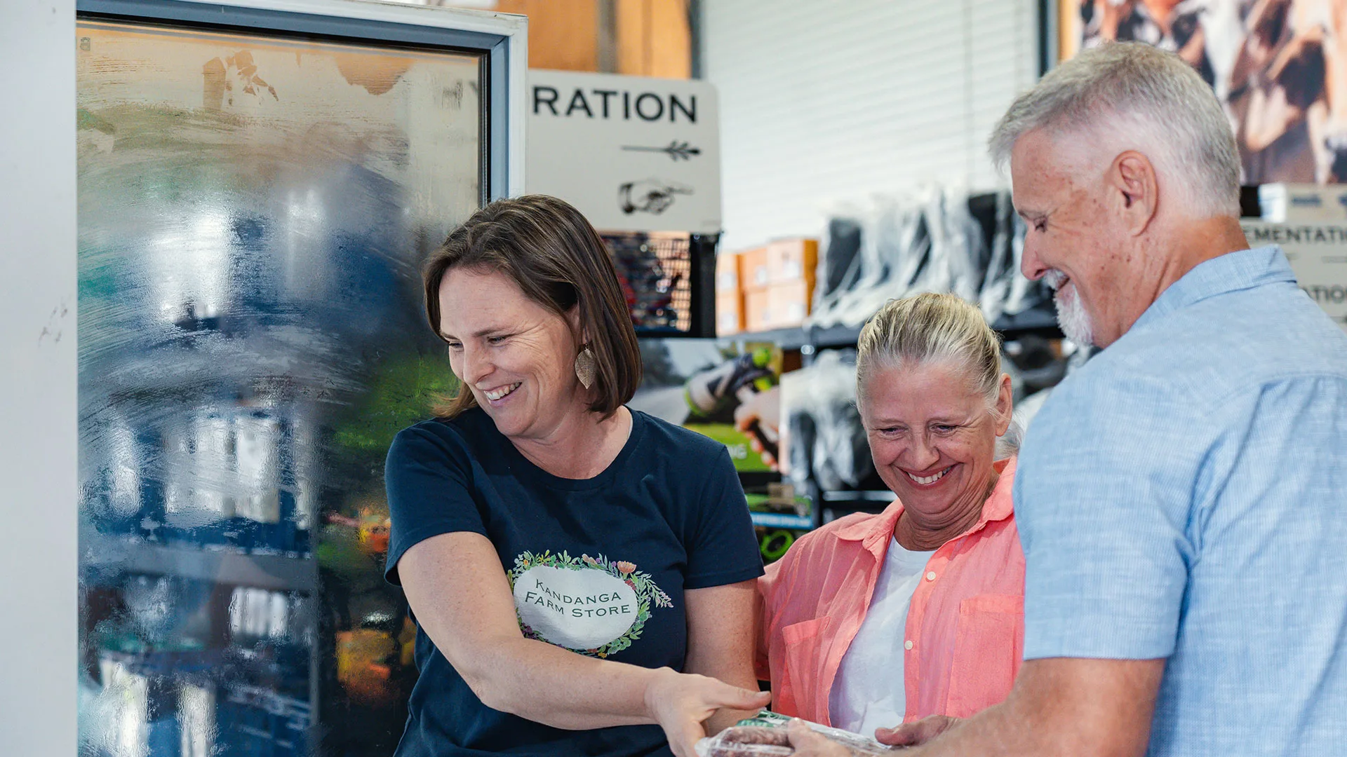 Amber Scott, Owner of the Kandanga Farm Store helping customers shop for local produce