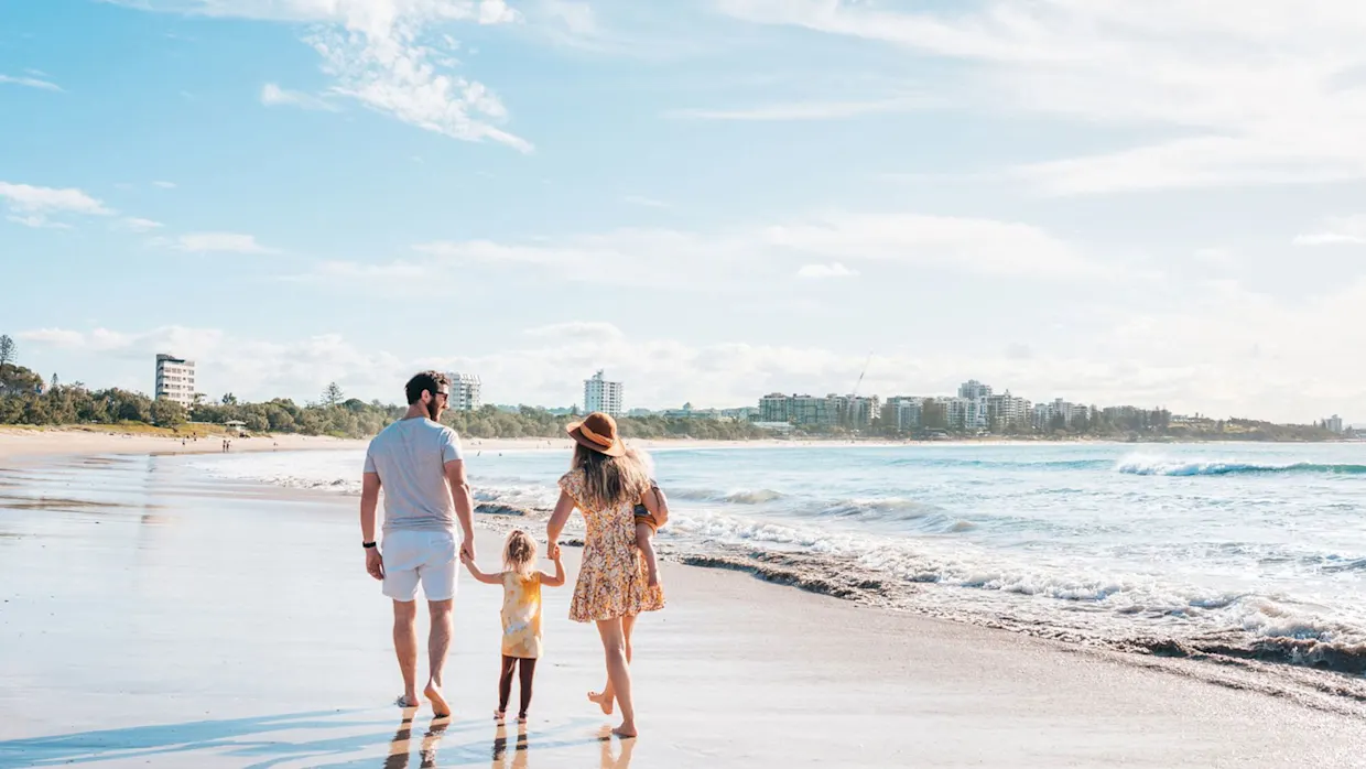 Family walking at Mooloolaba beach