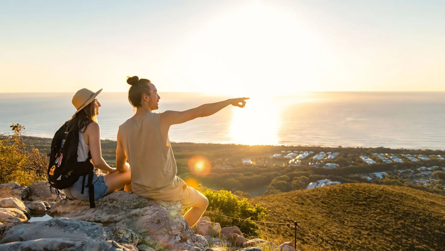 Couple enjoying the sunrise from Mt Coolum.