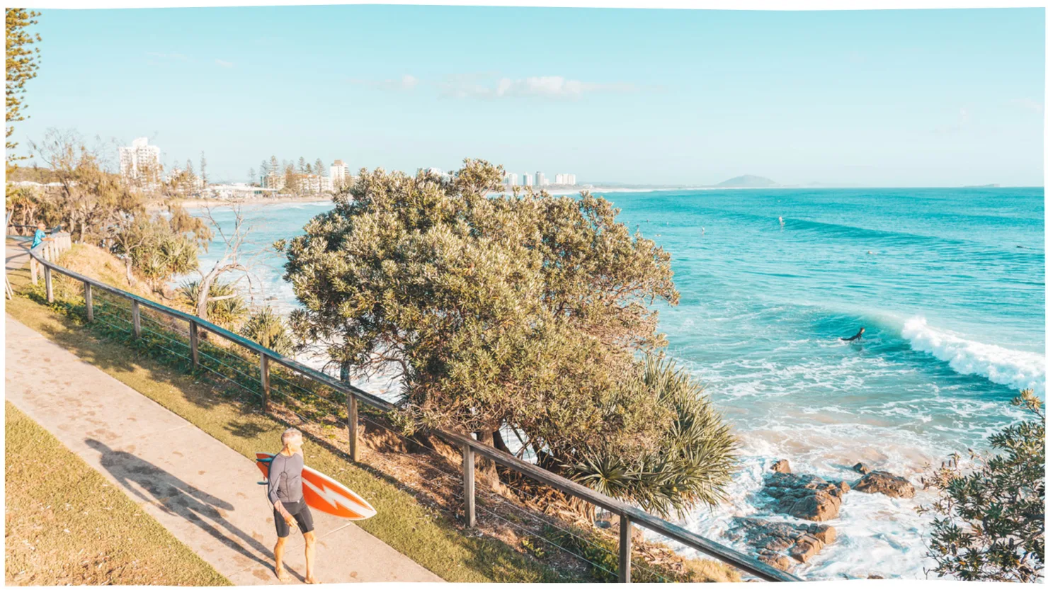 Surfer walking along at Alexandra Headland