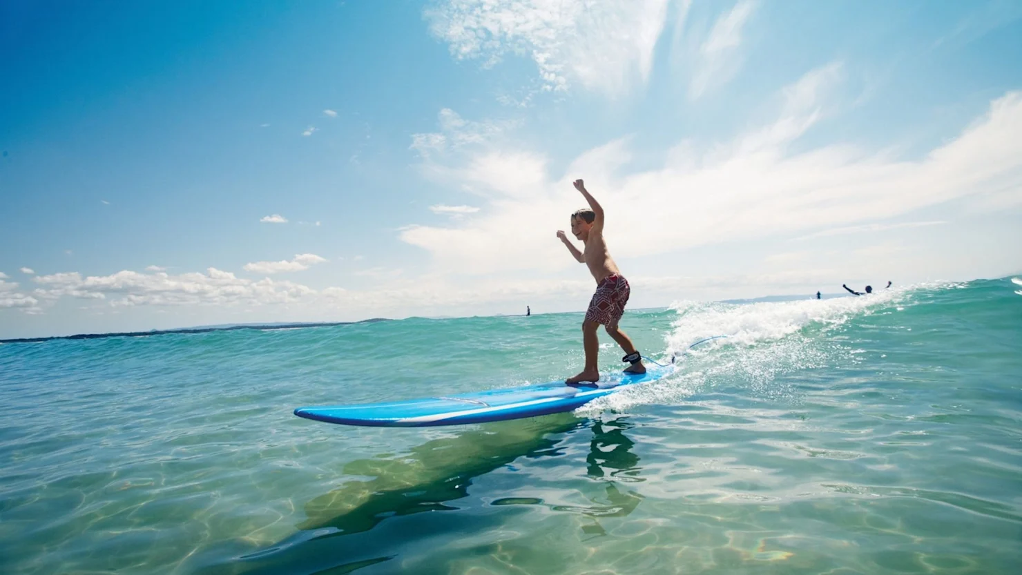 Kid surfing at Happy Valley, Sunshine Coast