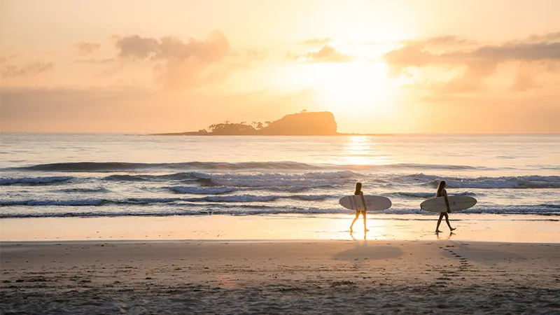 Two surfers at sunrise, Mudjimba beach