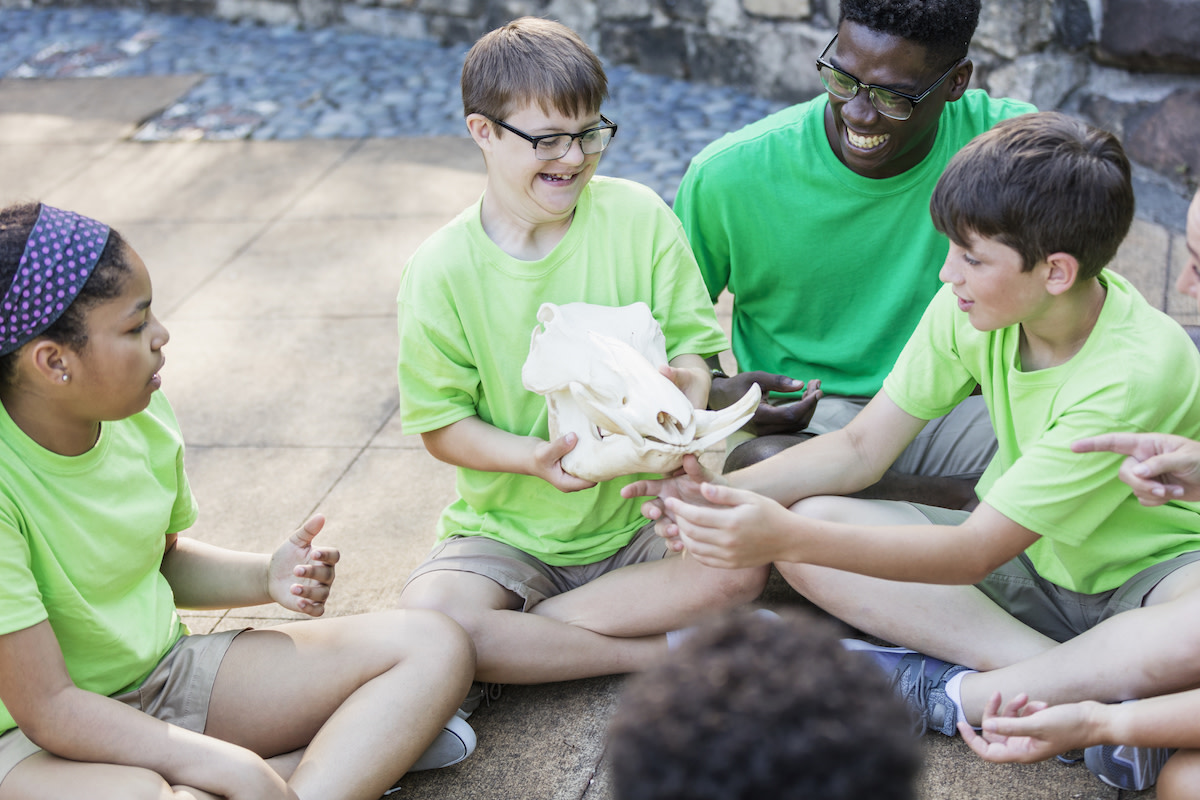 A group of students holding a skull and laughing.
