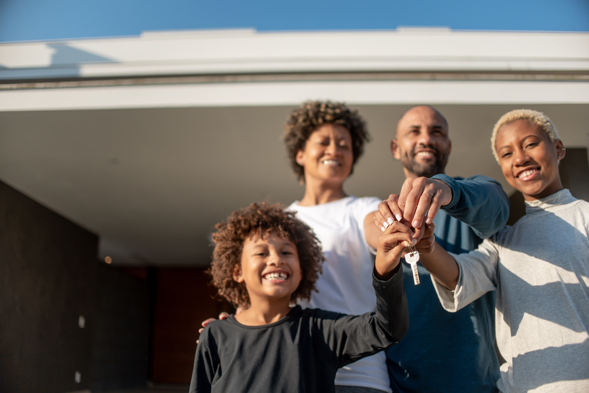 A family holding a key to a new home.