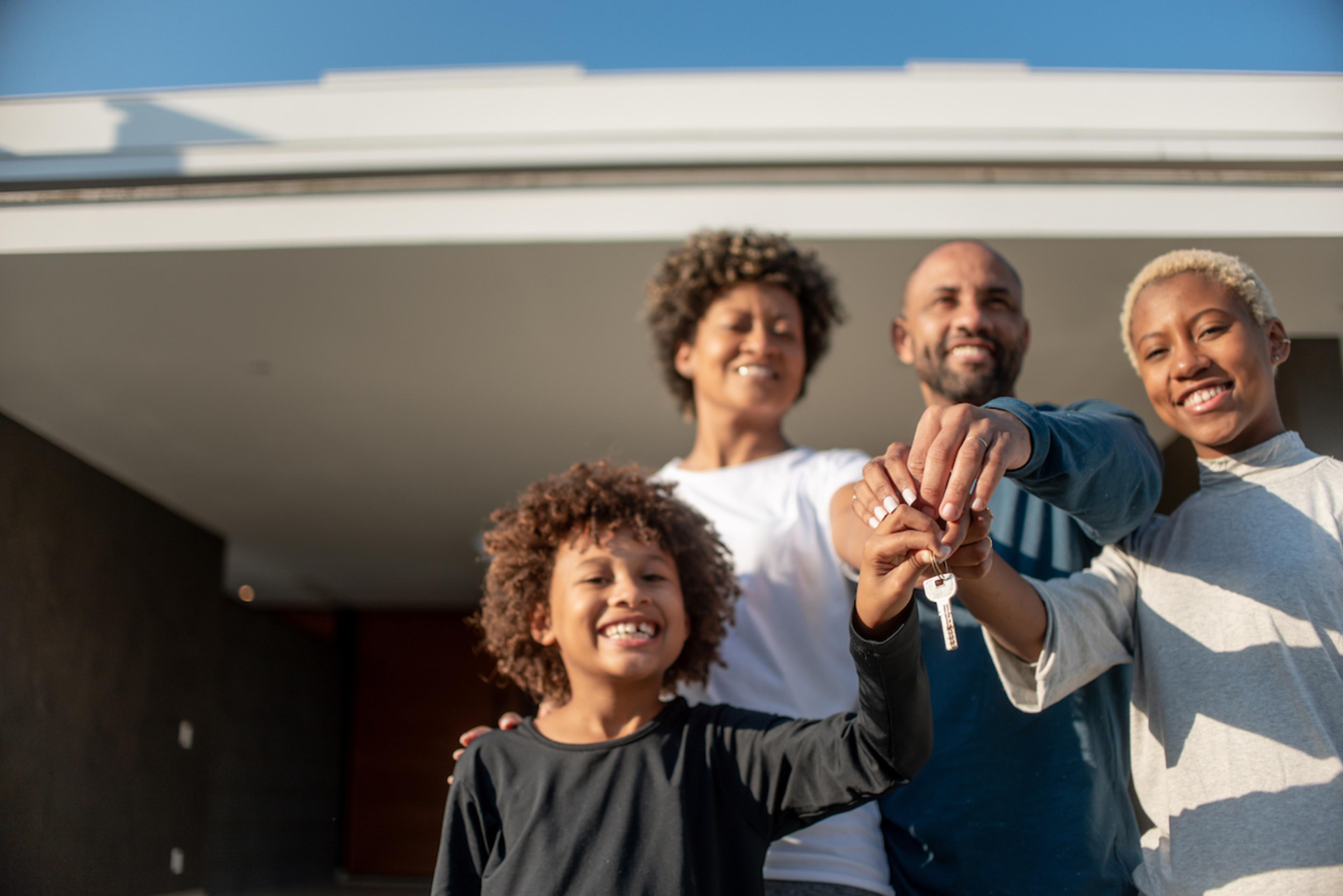 A family holding a key to a new home.