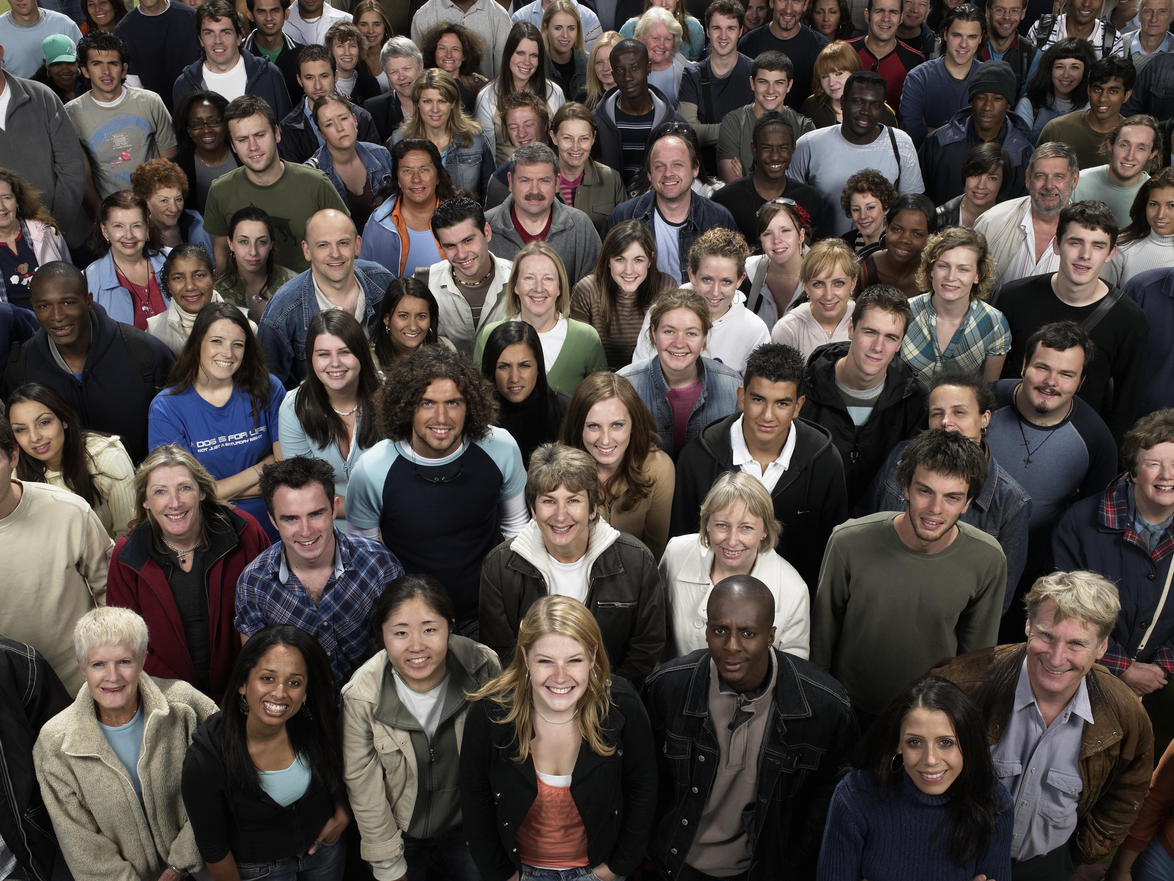 Large group of people that fill the entire image, all standing together.
