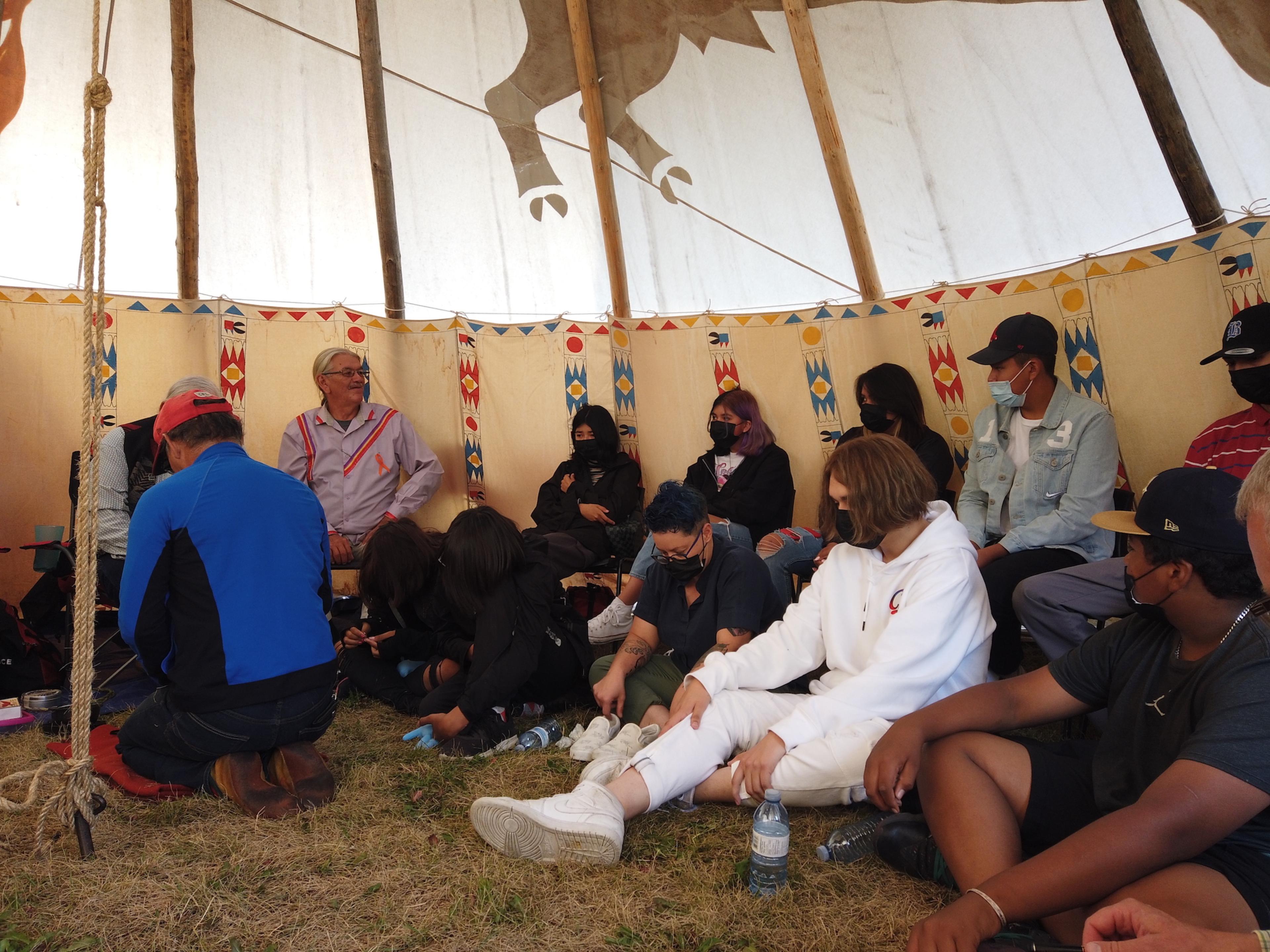 People gather in a tent