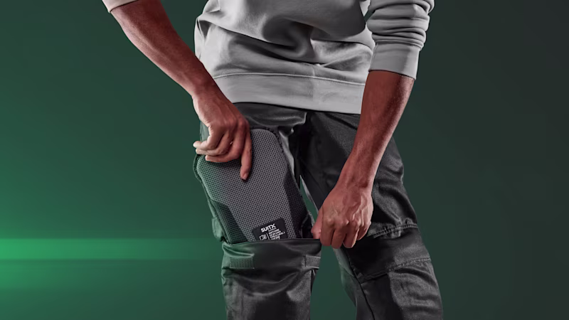 A man pushes the right knee pad into his trouser pocket