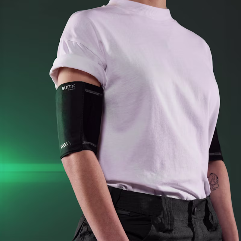 A woman in white t-shirt wears SUITX CX COOL SLEEVES on both upper arms
