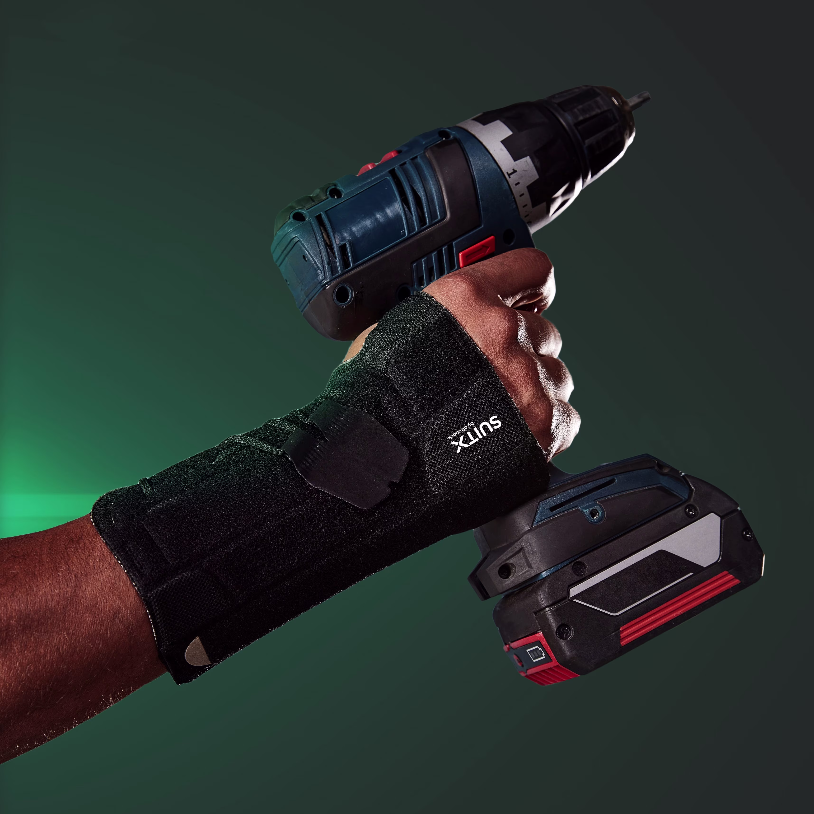 Outstretched arm, hand holding a cordless screwdriver. The hand is supported by a CX Soft Wrist.