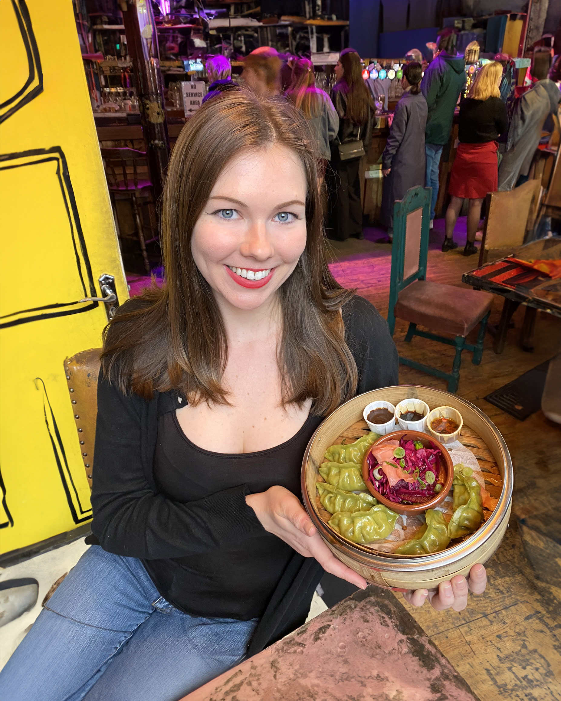 Deanna eating vegan dumplings in London, England.