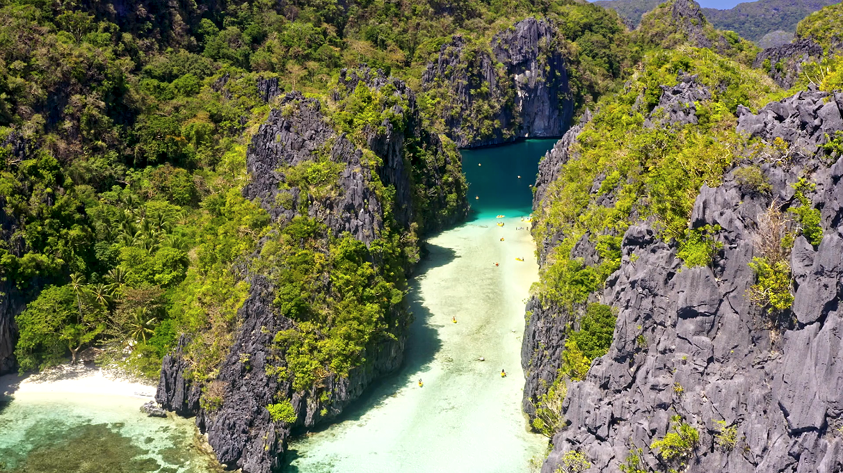 There is a long stretch of low-tide sand bank before you enter the mouth of the Big Lagoon in Palawan Philippines (Drone footage from artist: "Brusonja" from gettysignature on Canva)