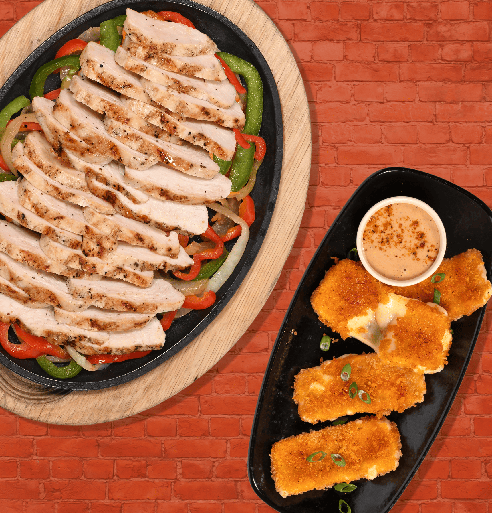 chicken Fajita on platter with onions and peppers. Another plate with crispy mozzarella showing melted cheese and a bowl with dip. 