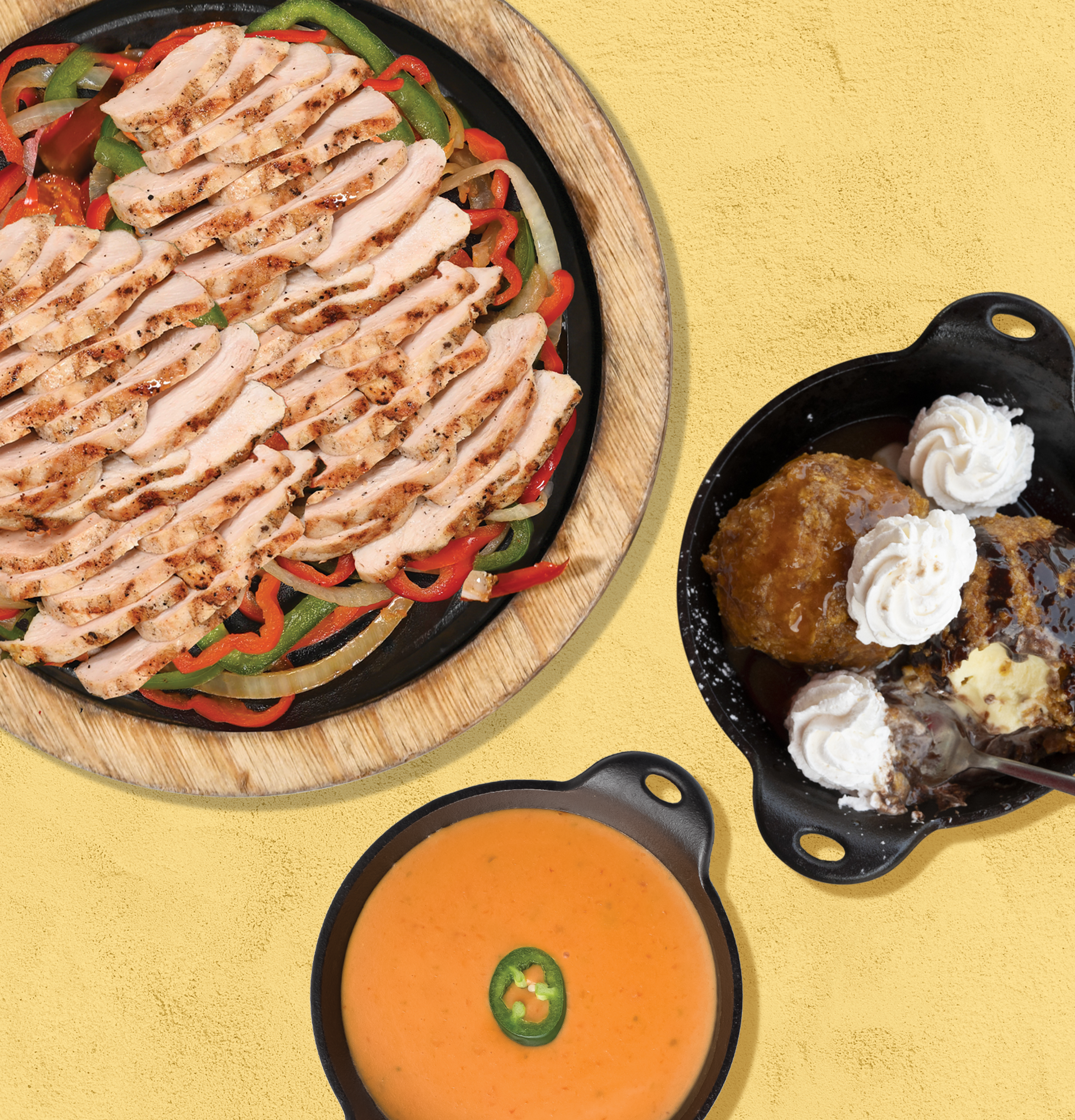 Hot plate of chicken fajita with pepper and bowl of queso cheese dip with a jalapeno slice on to, and depp fried ice cream in cast iron pan with whipped cream. 