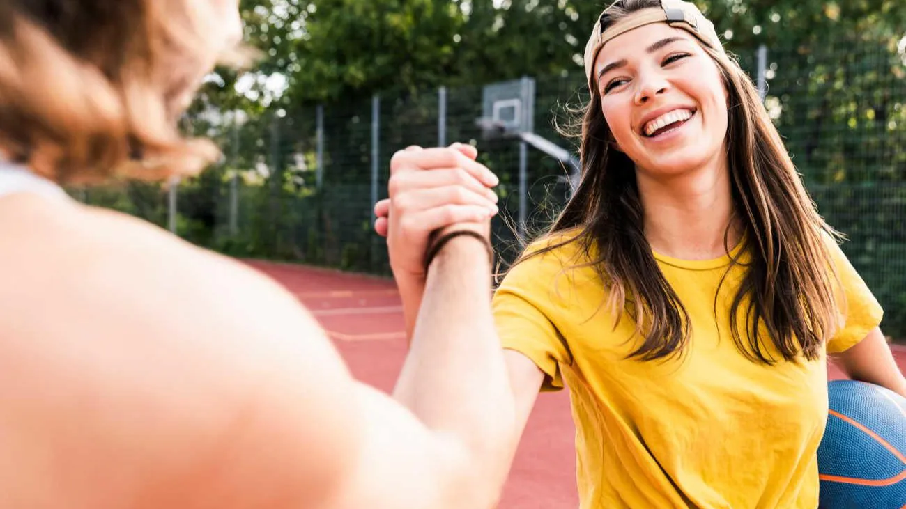 Woman playing basketball smiling