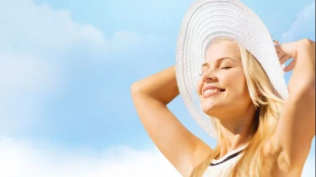 Woman smiling at sun