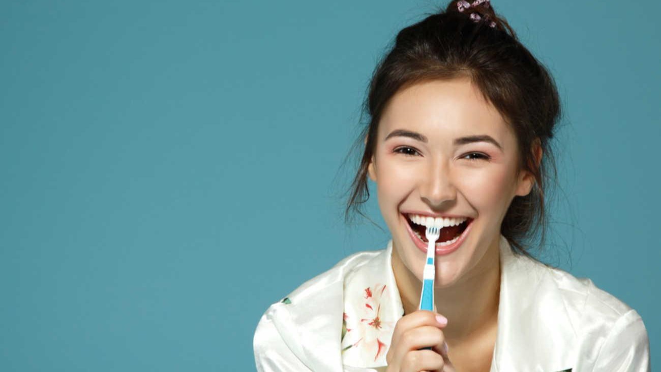 Woman smiling with toothbrush